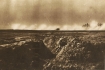 World War I soldiers in a trench near Craonne in 1917, with smoke from artillery on the horizon.